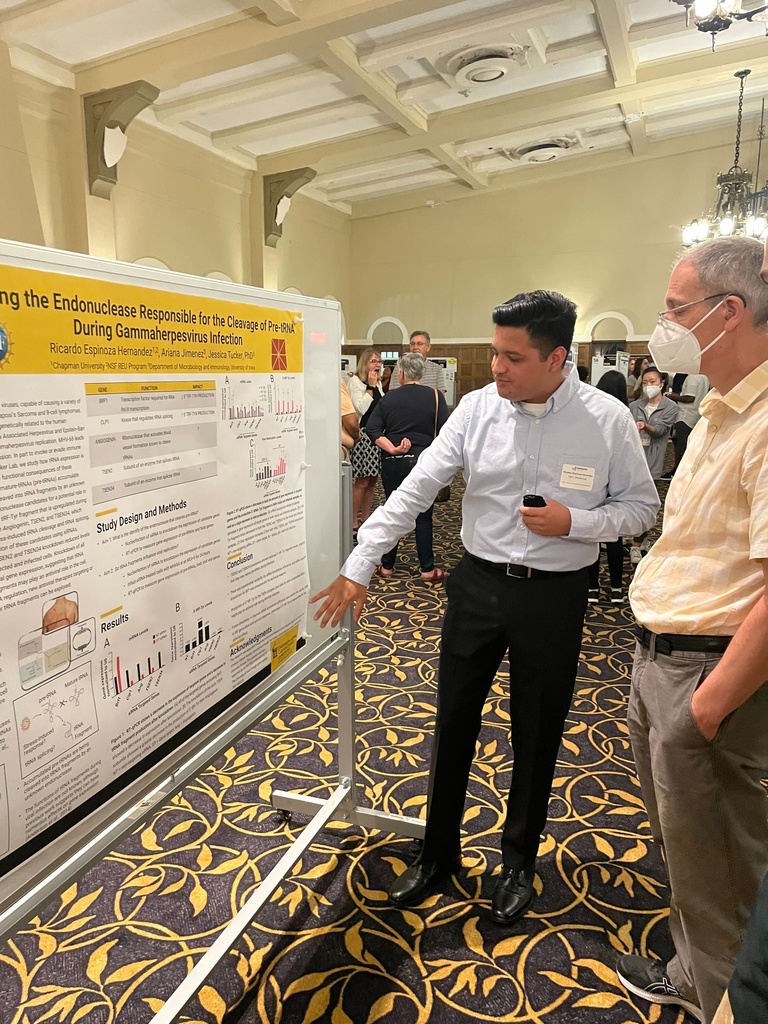 Ricardo presents his poster at the Summer Undergraduate Research Conference.